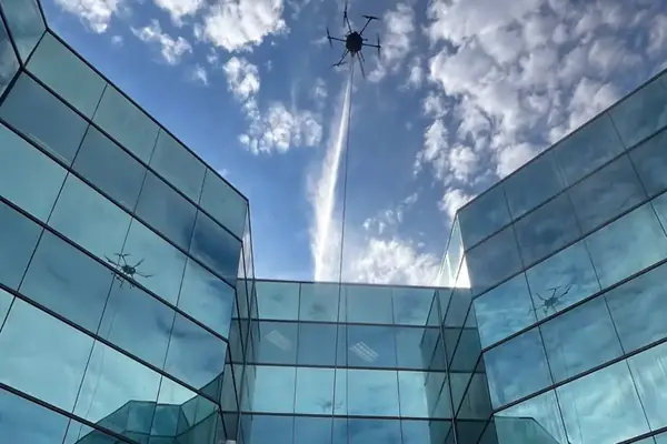 Tethered drone washing the upper walls of the courtyard at an office building in Smyrna, GA