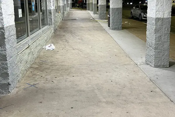 Covered storefront walkway with stone-clad columns at a shopping center in Stone Mountain after cleaning