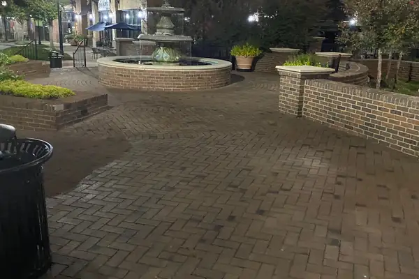 Brick paver courtyard and fountain at a shopping center in Suwanee, GA, after a night pressure wash
